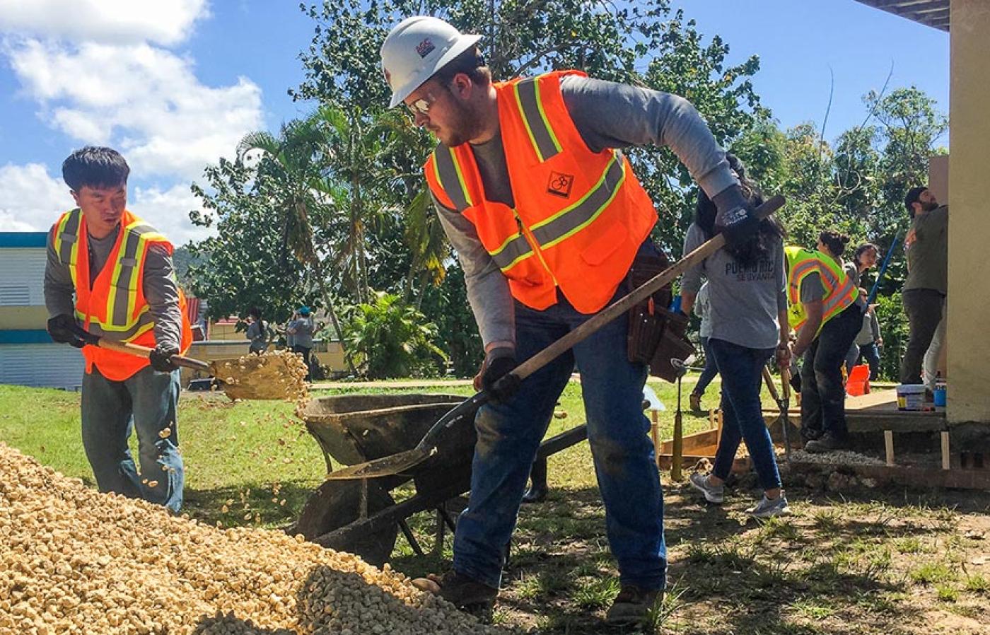 Construction engineers digging with a shovel