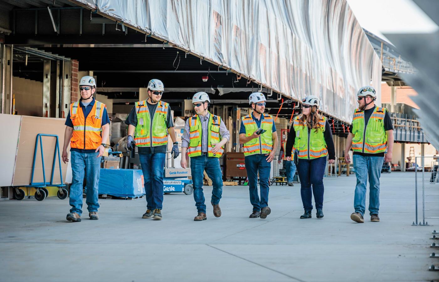 Civil Engineers in construction uniform walking together 