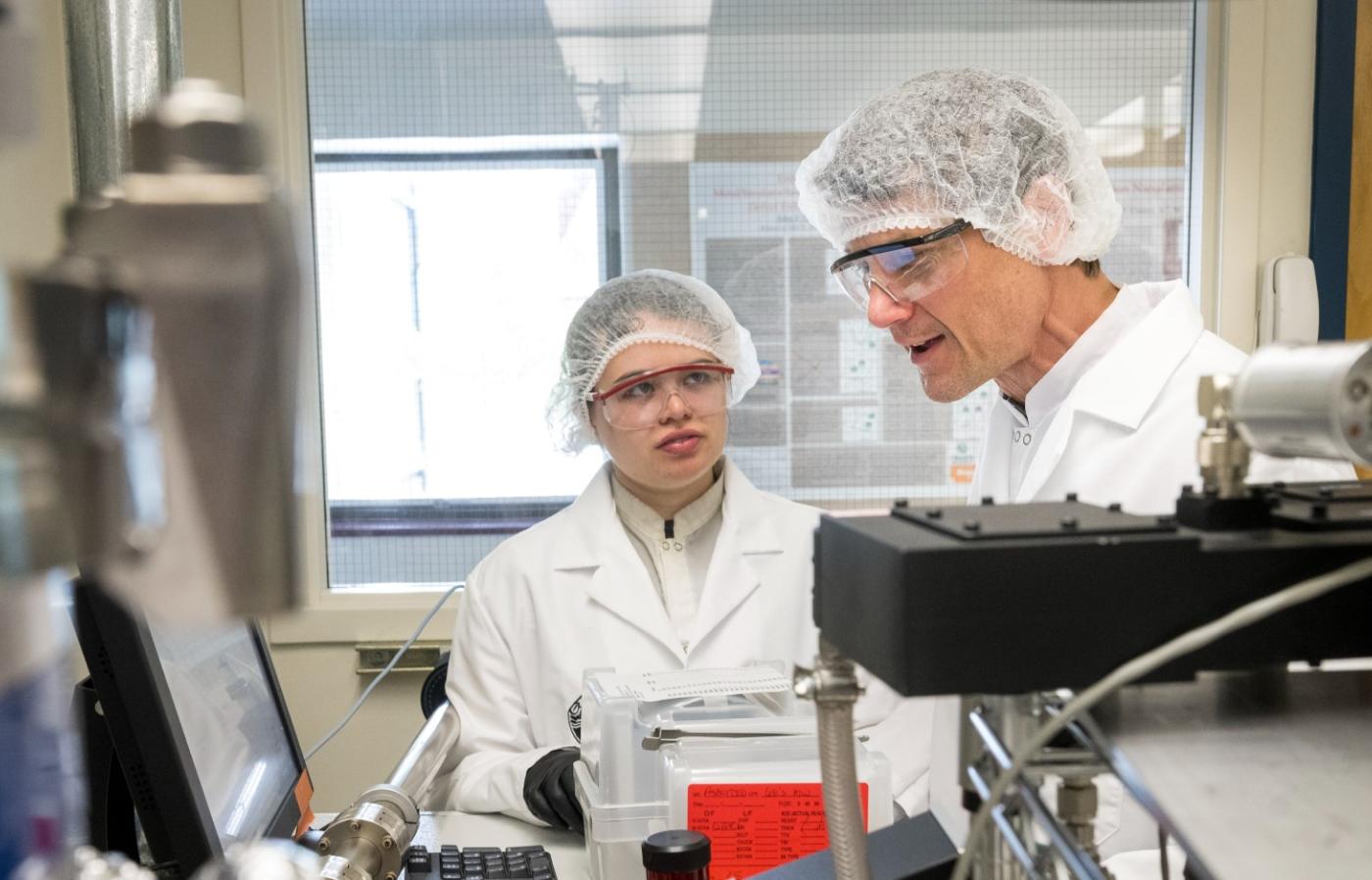 John Conley working with a student and showing tools