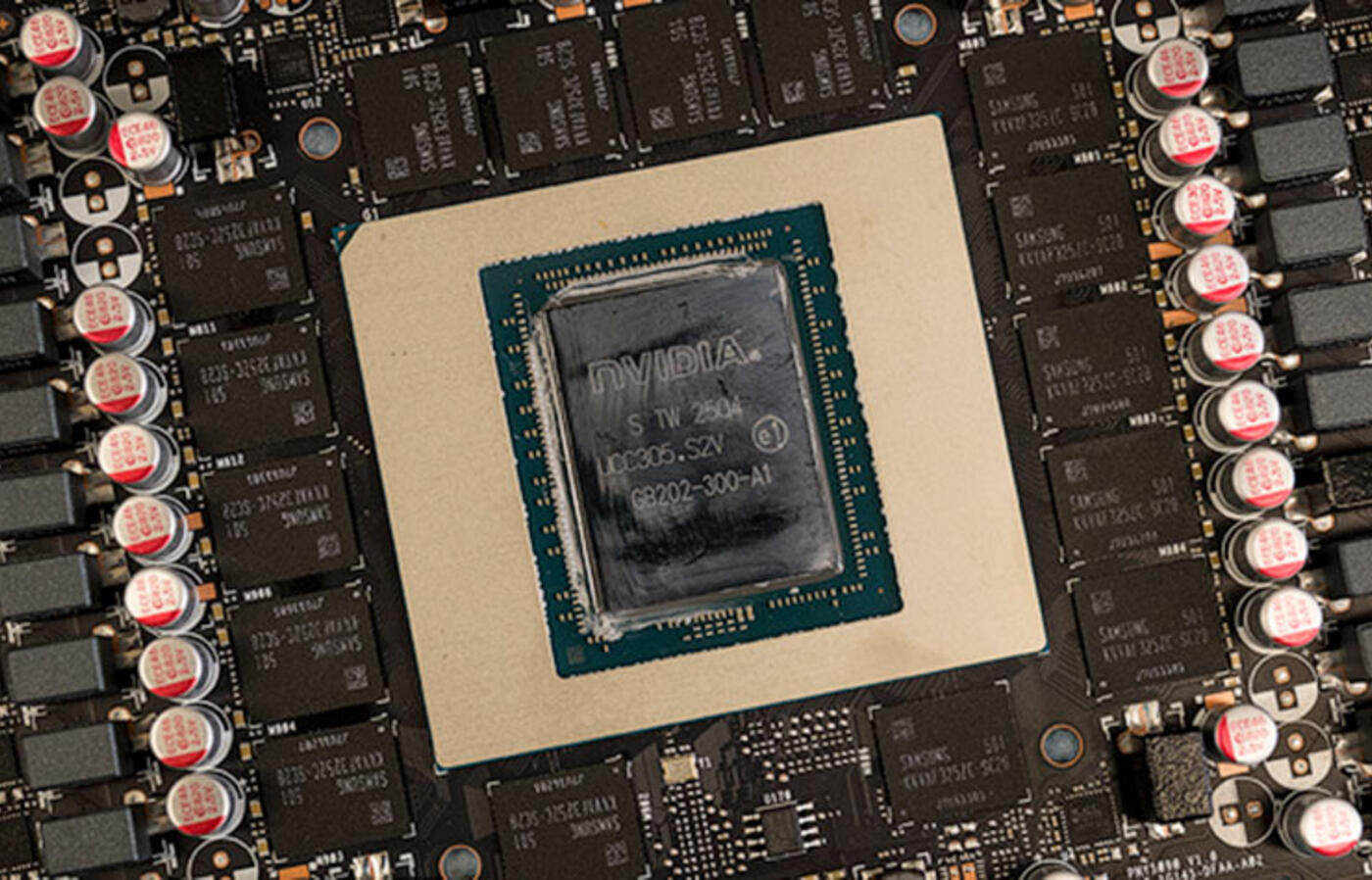 Close-up view of a graphics card chip board, showing the arrangement of the NVIDIA unit in the center, surrounded by other components. 