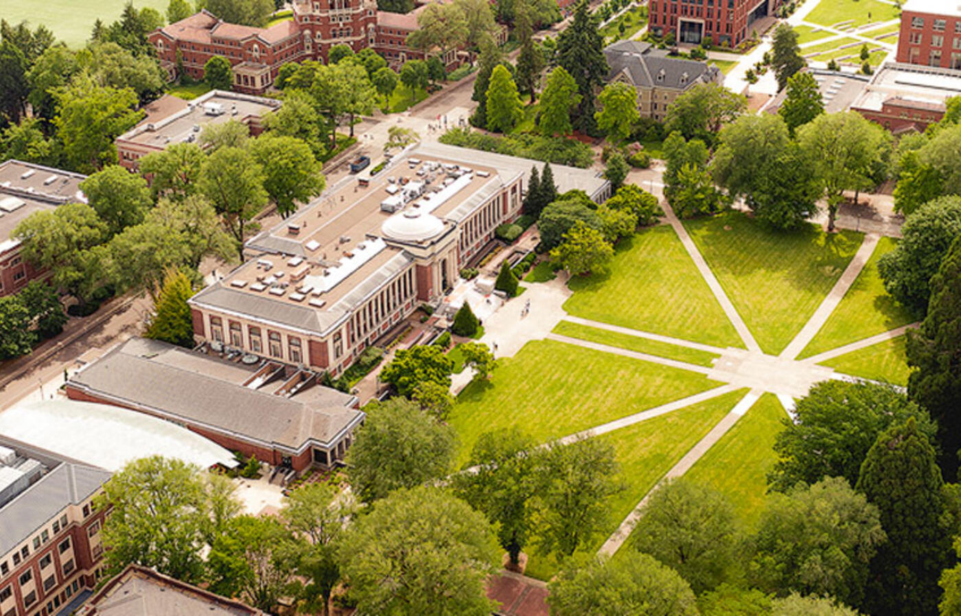 Oregon State University campus seen from above with green vegetation, buildings, and walking paths.