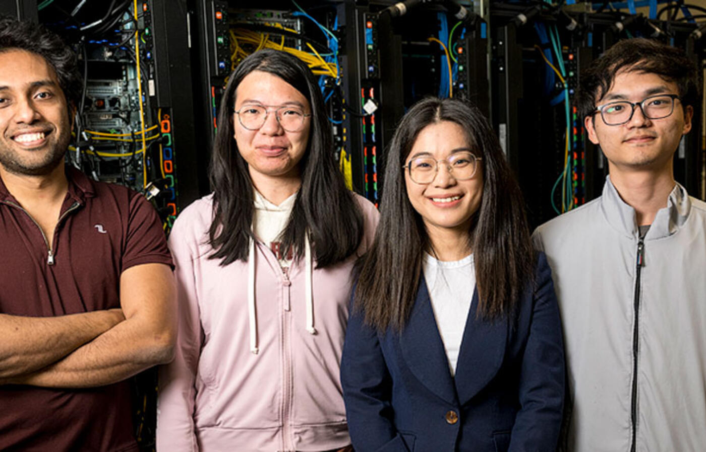 Arunavo Dey, Xulu Chu, Wenqian Dong, and Changqing Li pose in front of a rack of computer servers.
