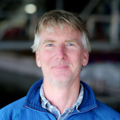 Man wearing blue jacket facing camera.