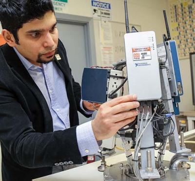 Erdem Coleri performing sensor adjustments on the Oregon Field Tack Coat Tester