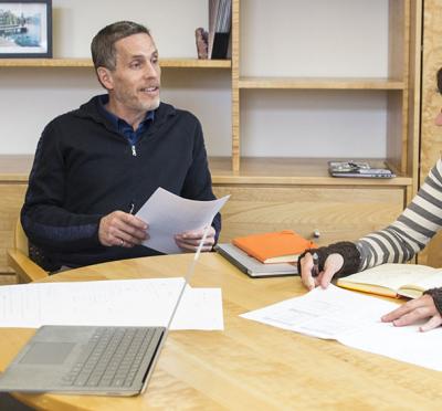 Tom Weller in a meeting with two other people.