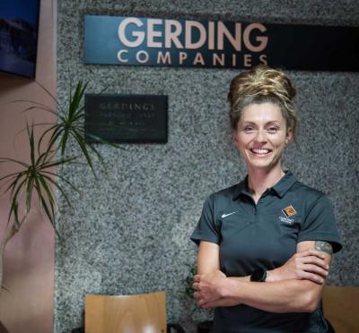 Tausha Smith standing in front of a Gerding Companies sign.