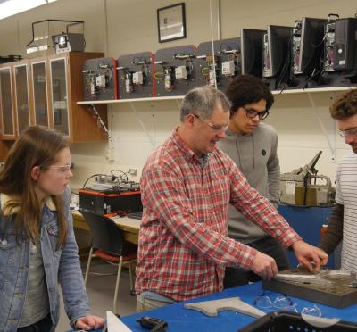Scott Campbell, an instructor in the School of Mechanical, Industrial and Manufacturing Engineering, prepares a demonstration for students in a manufacturing lab.