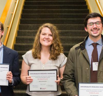 Graduate students John Morrow, Grace Burleson and William Maurer posing together for a photo with their 2018 graduate research showcase awards.