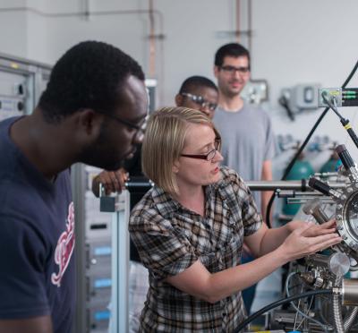 A group of people looking at a machine.