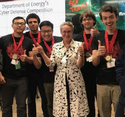 Student team standing with award necklace. 