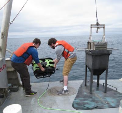Dylan Jones and Seth McCammon deploy a Seabotix remotely operated vehicle in the ocean