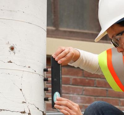 A women in a construction jacket doing work.