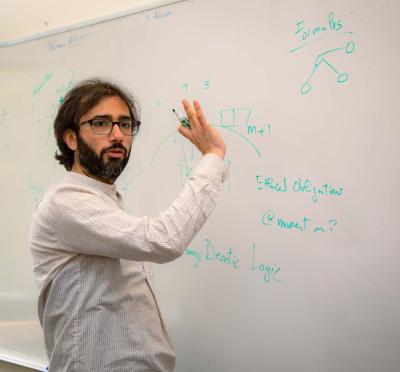 Researcher in front of a whiteboard. 