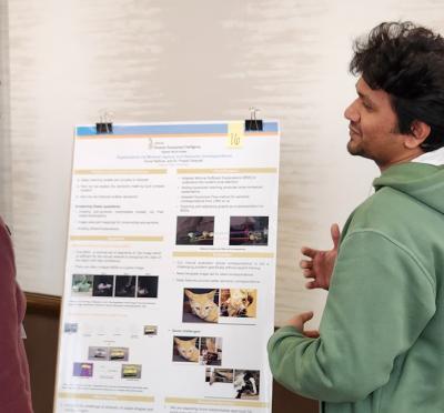 People looking at a research poster