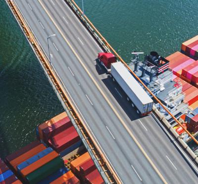 Semi-truck transporting over a bridge