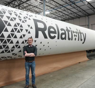 A.J. Fillo standing in front of a rocket 