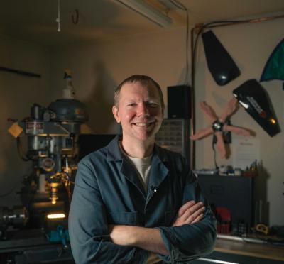 Quint Crispin posing in front of projects he has made