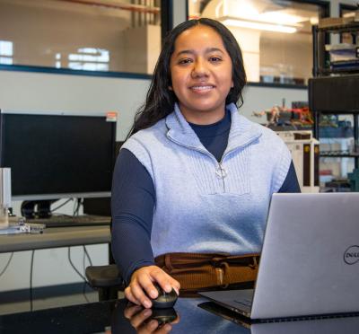 Lesly Rojas is sitting in front of her laptop in her office.