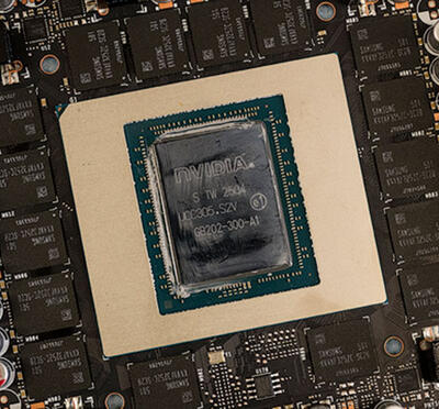 Close-up view of a graphics card chip board, showing the arrangement of the NVIDIA unit in the center, surrounded by other components. 