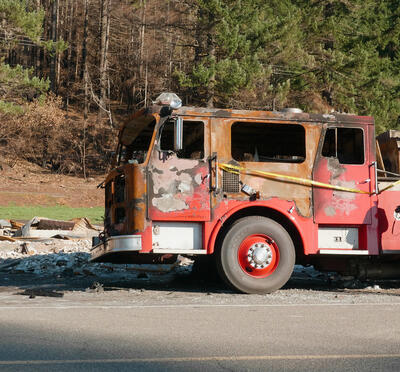 A man standing next to a firetruck.