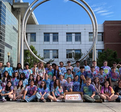 Engineering students posing with a cake.