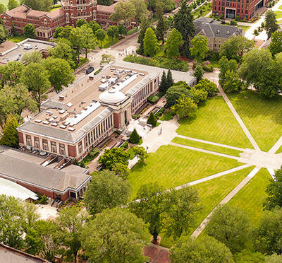 Oregon State University campus seen from above with green vegetation, buildings, and walking paths.
