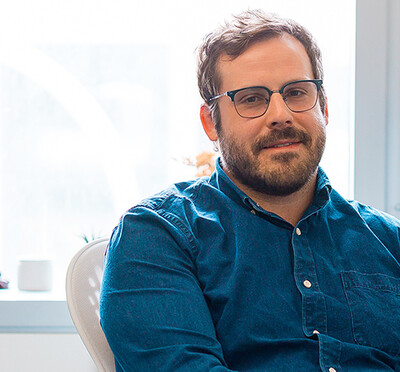 Kyle Hale, in his office with a window behind him, looks toward the camera.