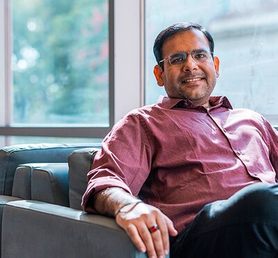 Manish Motwani sits smiling in a chair by the windows of Kelley Engineering.