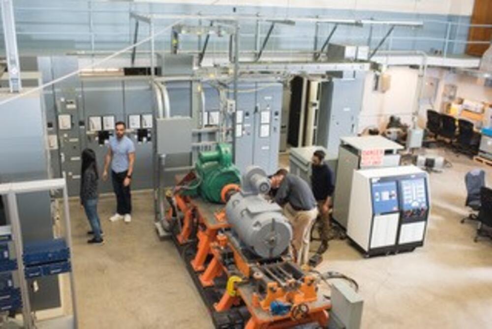Energy Systems group inspect microgrid electrical equipment in at the Wallace Energy Systems & Renewables facility.