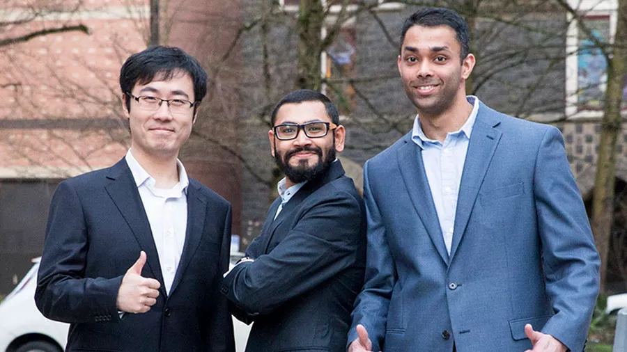 Three Oregon State engineering students standing together outside at the graduate research showcase