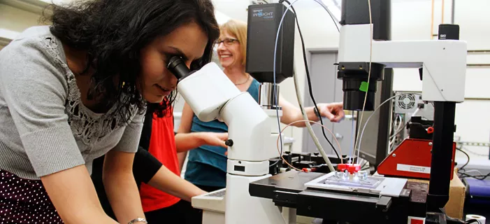 Picture of girl looking through telescope.