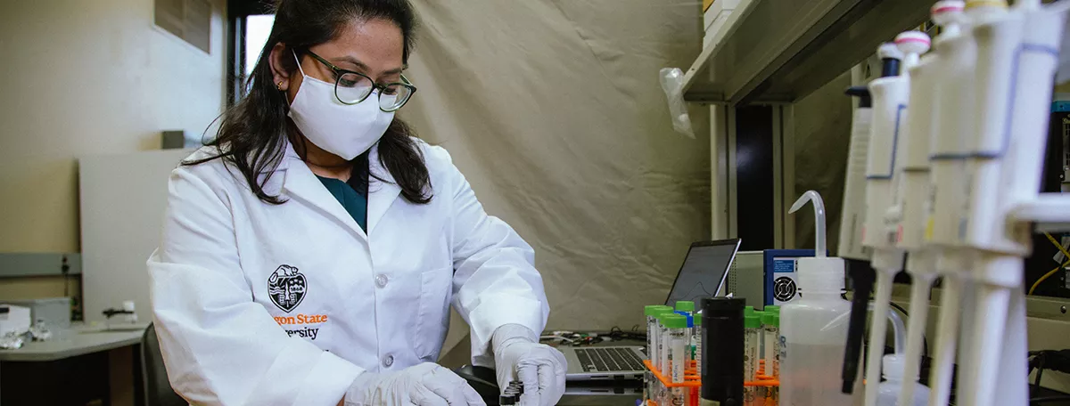 A picture of Sanjida Yeasmin working in a laboratory.