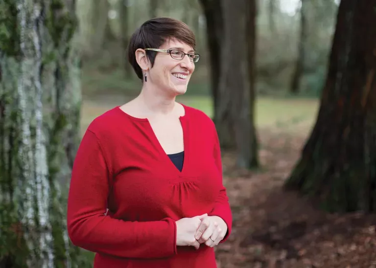 Portrait of Rebecca Hutchinson in a forest environment.