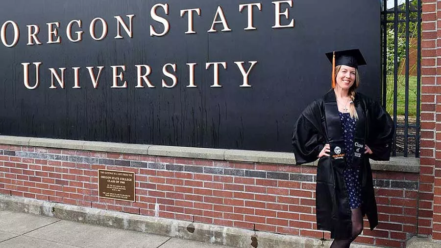 Brittany Blanksma-Stark posing in front of Oregon State University sign.