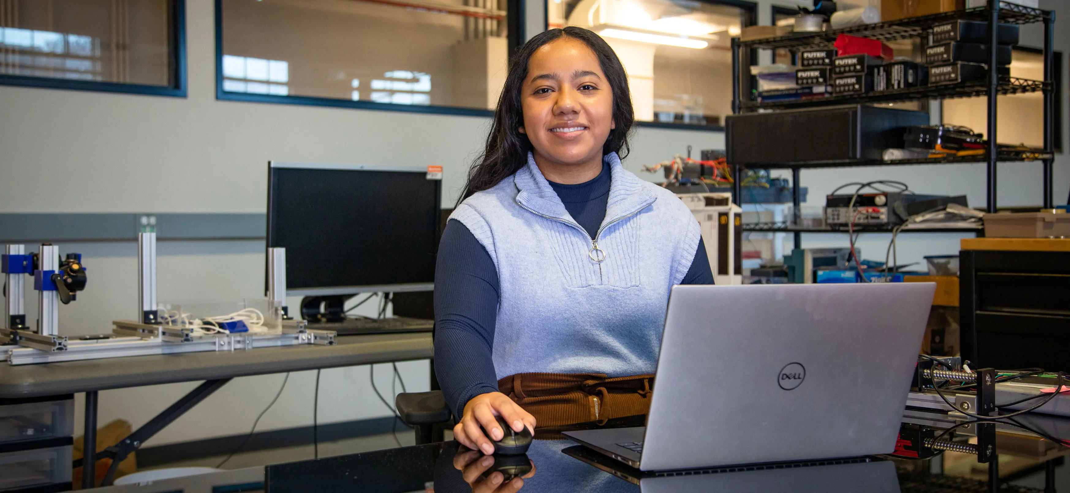 Lesly Rojas is sitting in front of her laptop in her office.