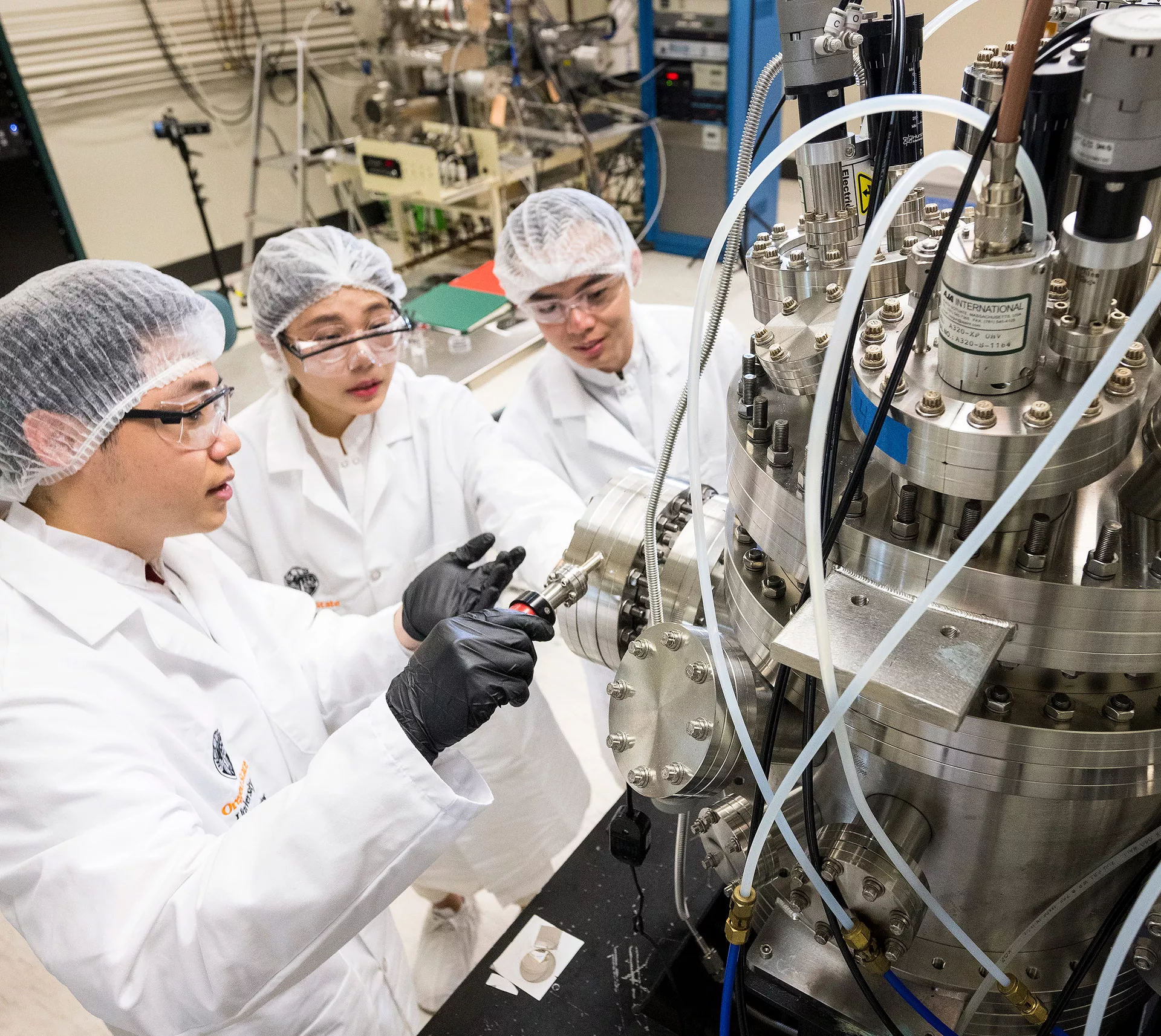 Three faculty members working in a lab.