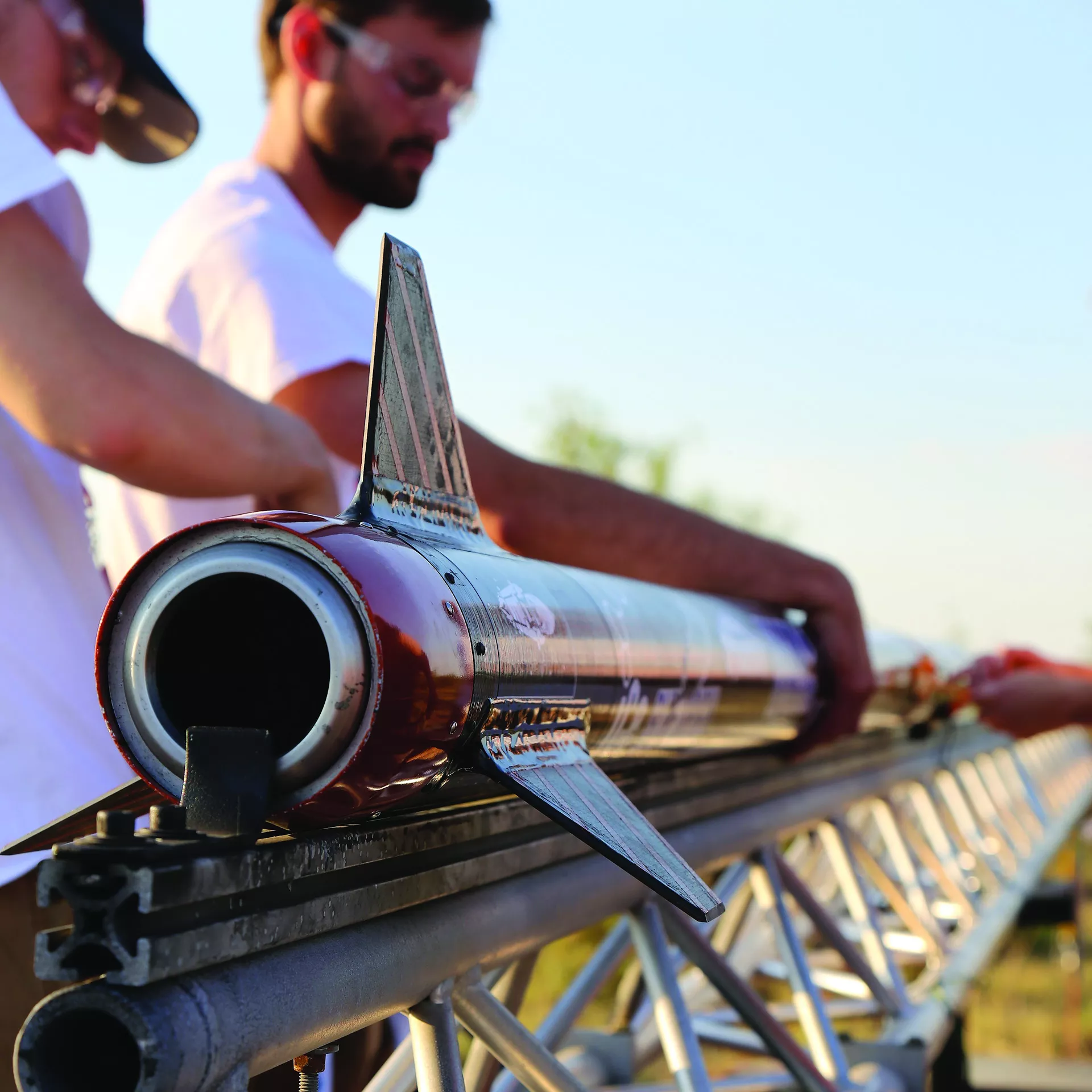 Students placing a small rocket on a track.