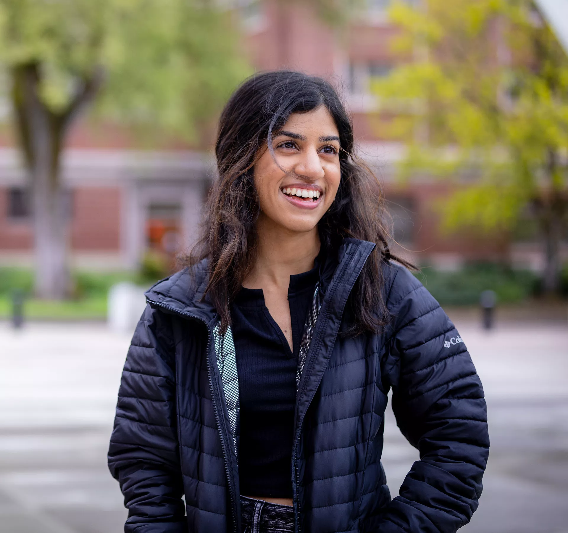 Subisha Sundaram standing outside.