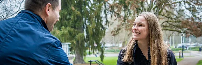 Two people outside shaking hands