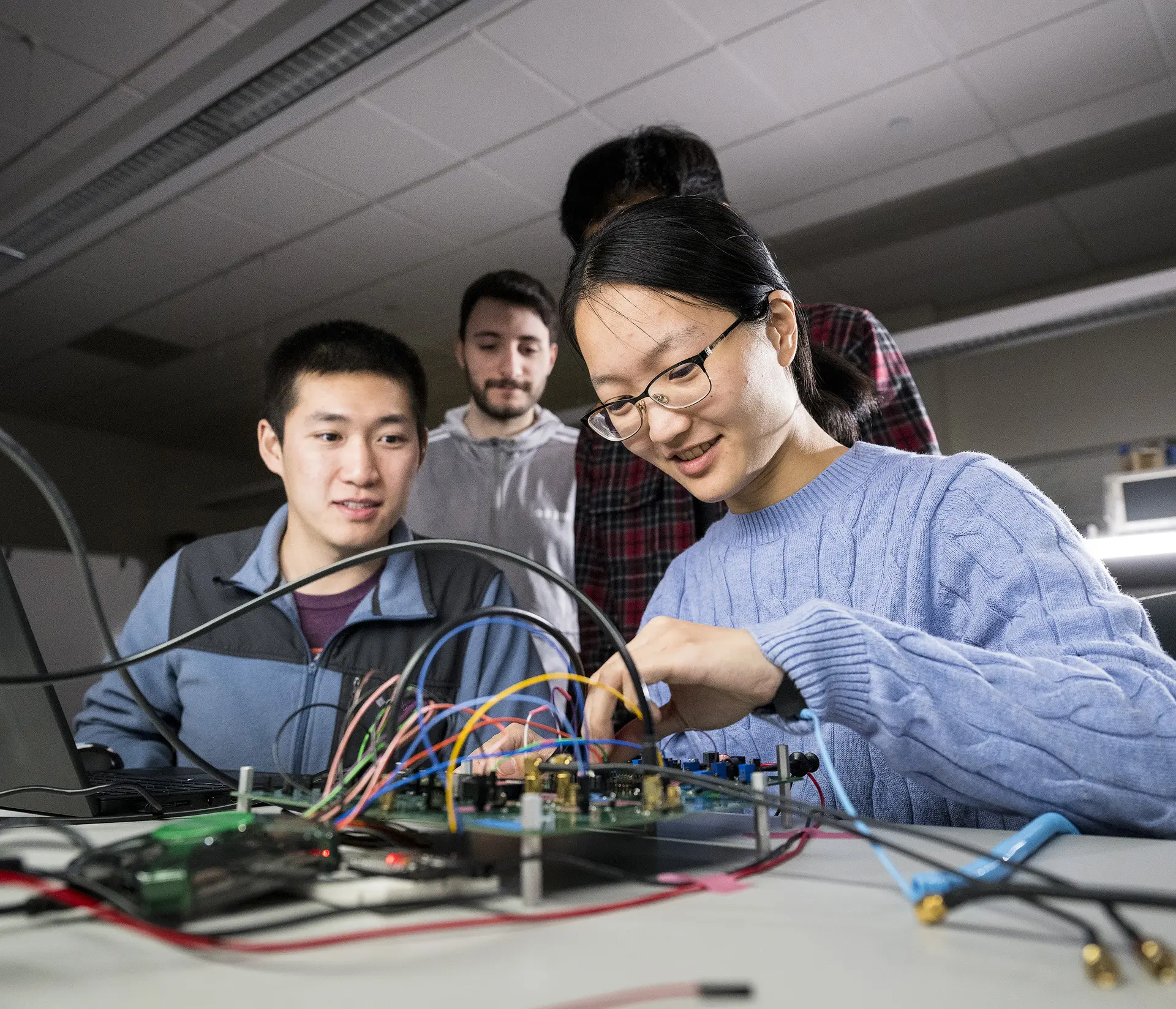 Four students working on a circuit