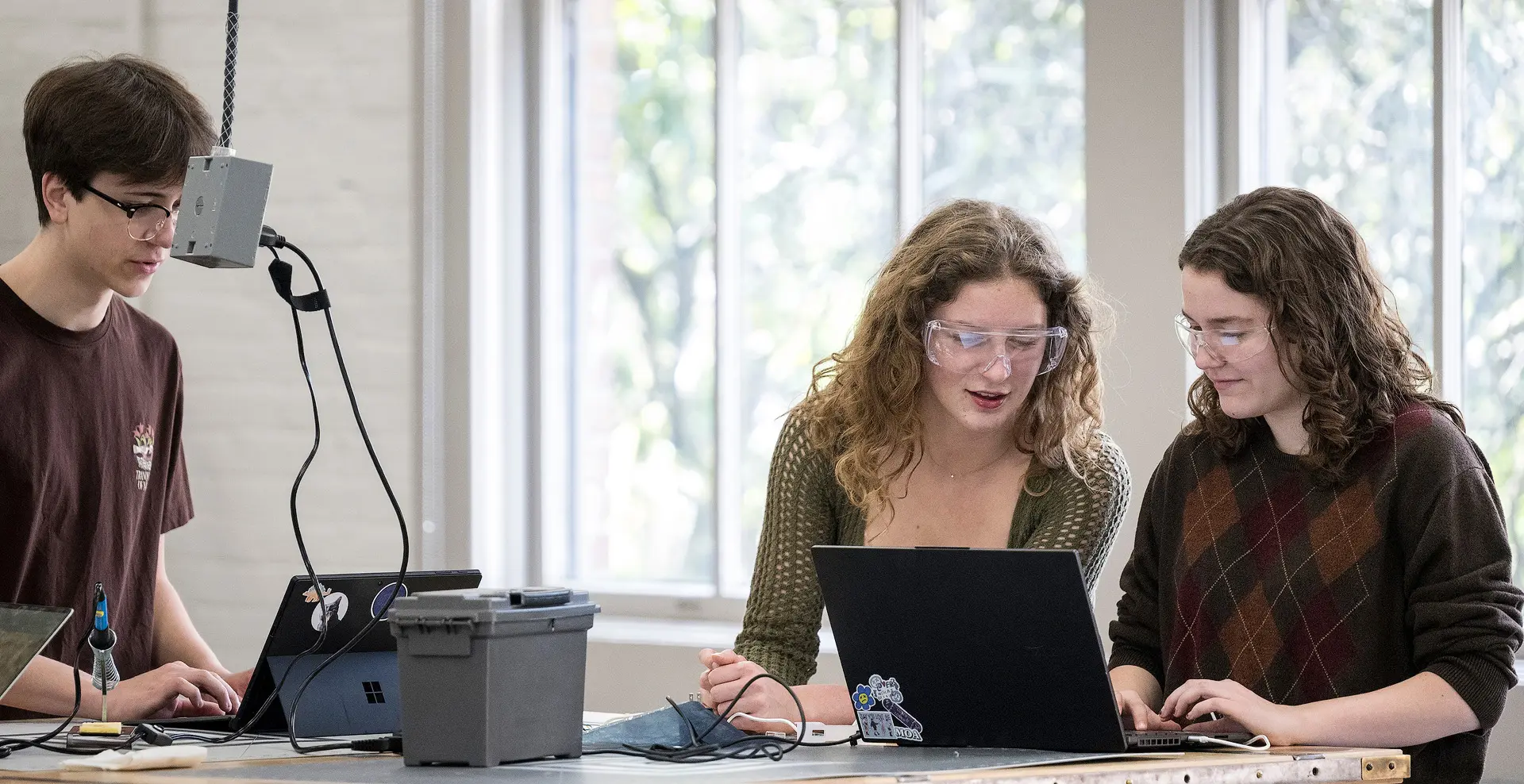 Three students working on a lab
