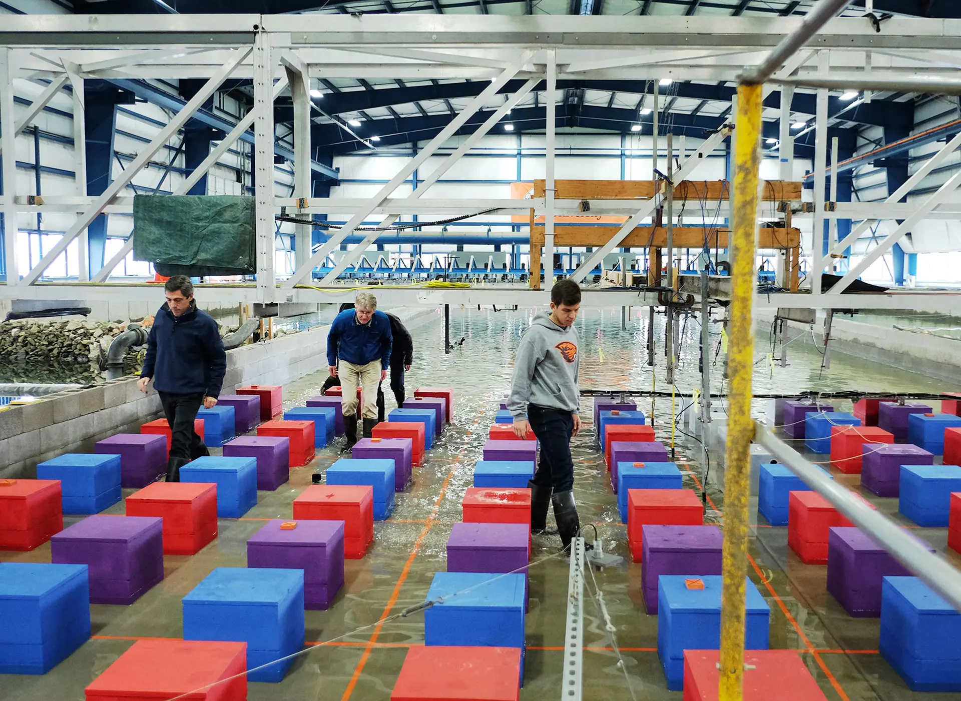 Wave Lab faculty examining equipment