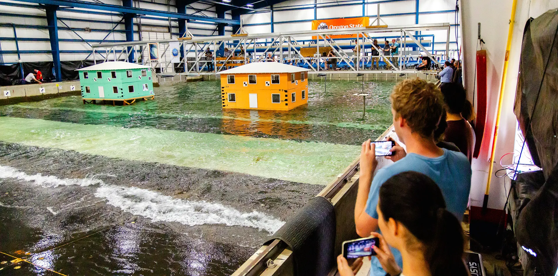 Students taking pictures of the wave lab.