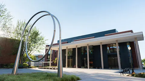 Metal spiral sculpture in front of Johnson Hall.