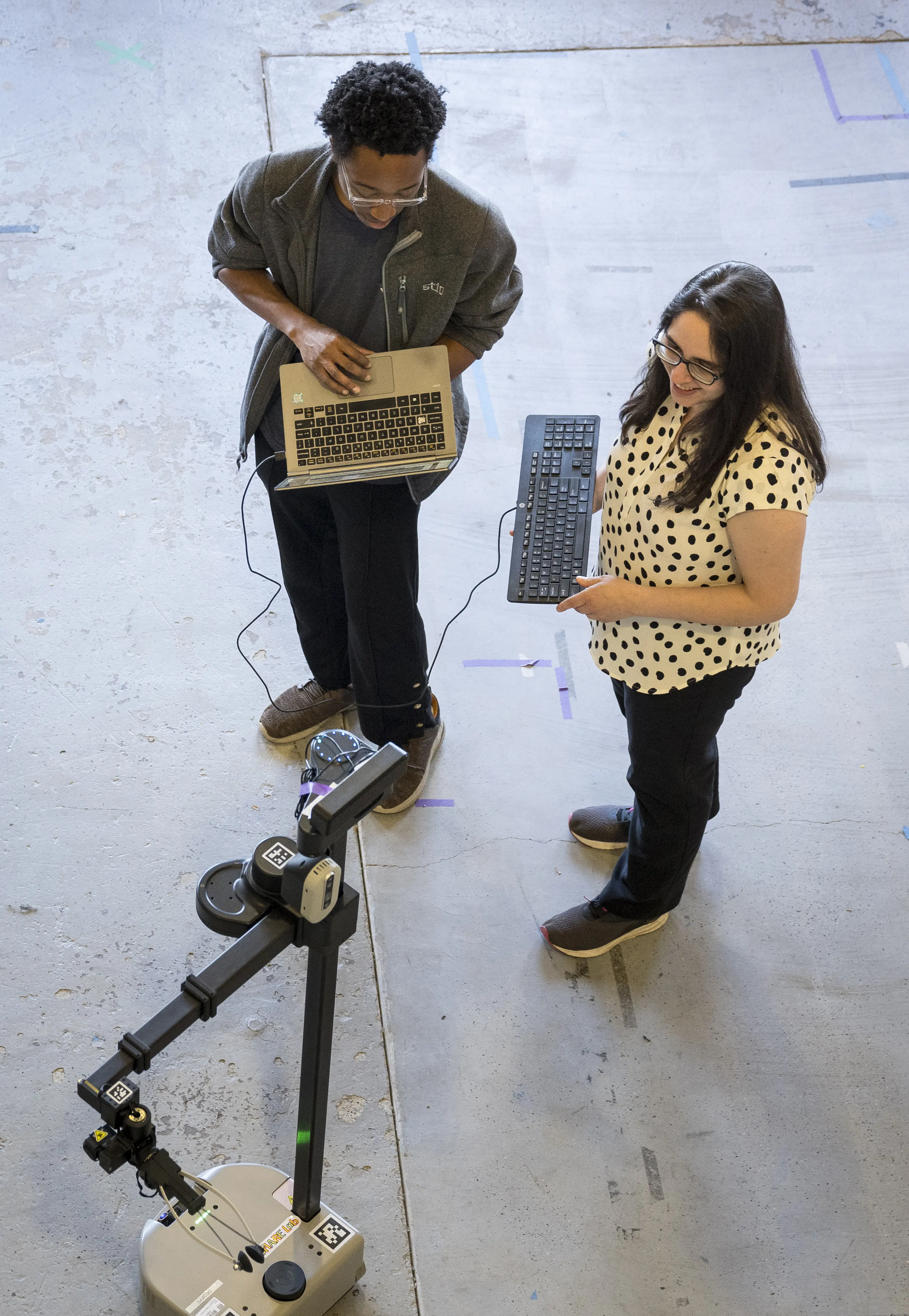 two students working on a robot.