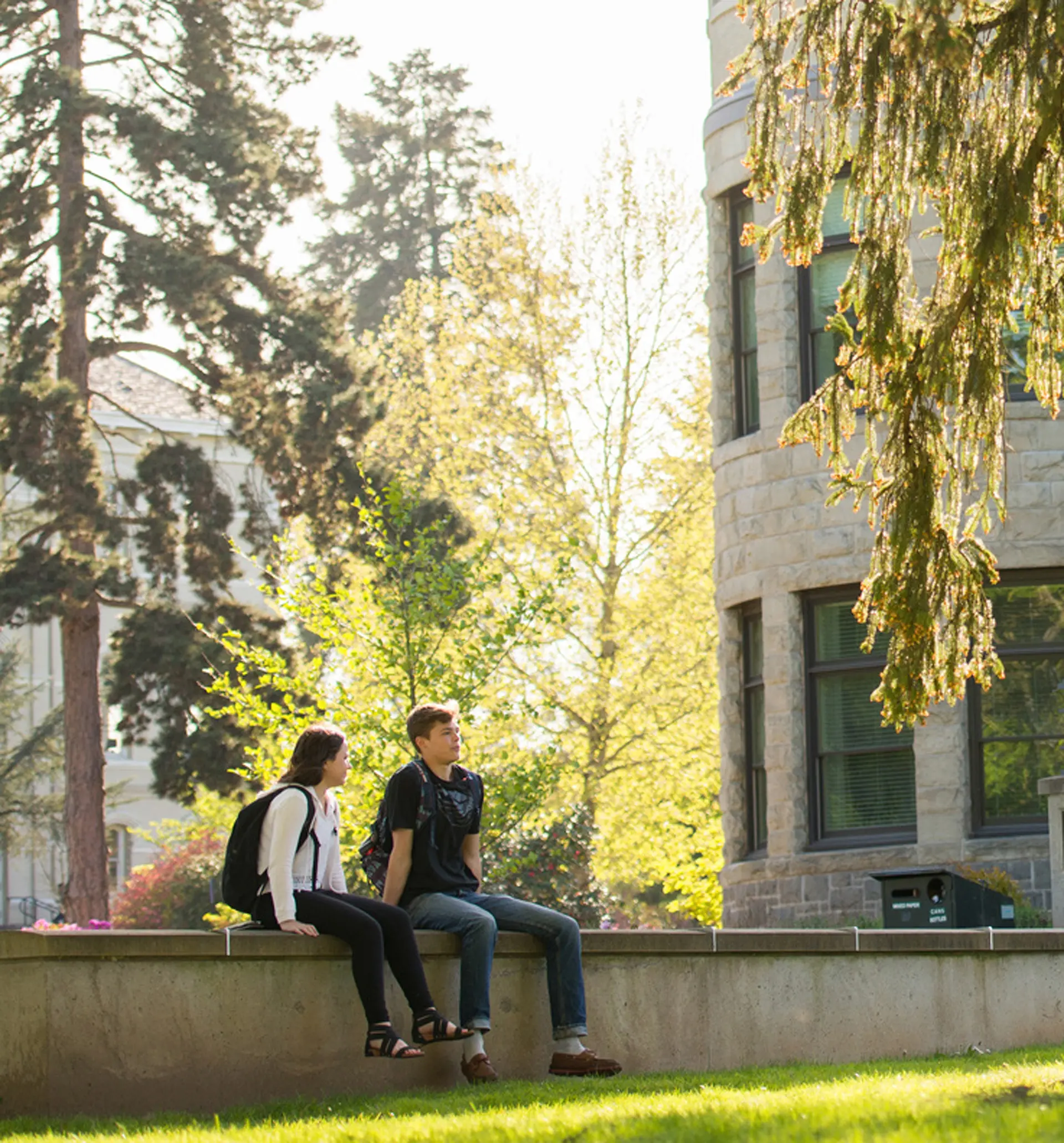 Two students sitting outside of Kearney Hall.