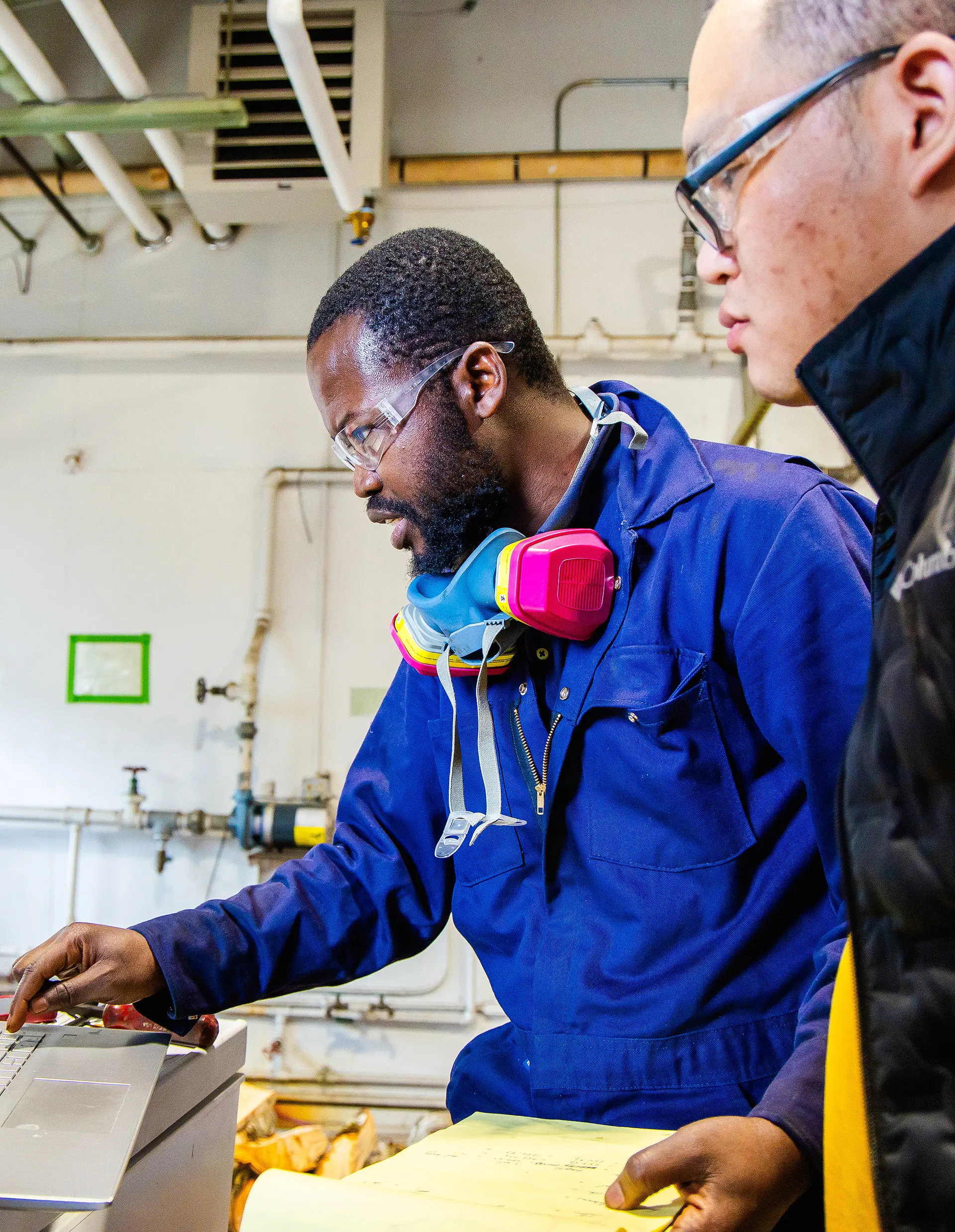 Two men inspecting a lab instrument.