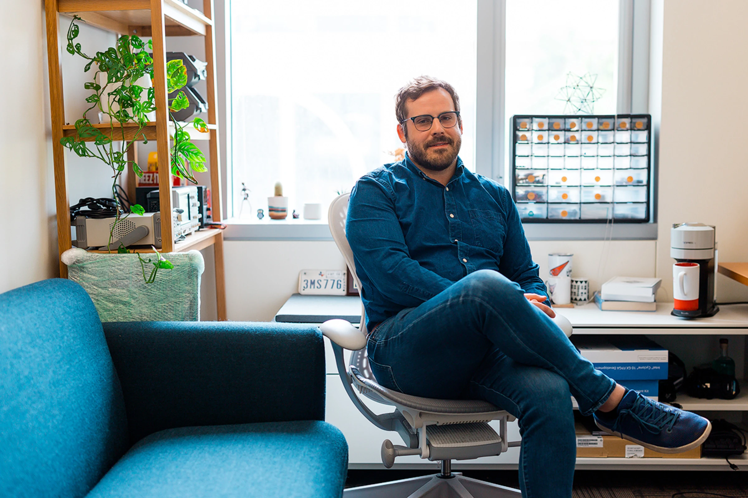 Kyle Hale wears glasses and a button-down shirt and sits in his office with a window behind him and looks toward the camera.