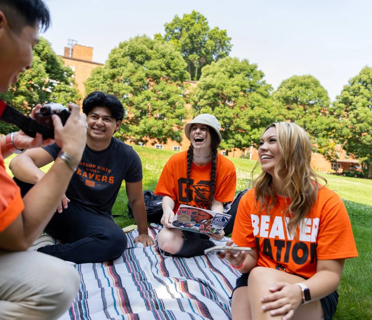 Group of students chatting in a circle on the weatherford lawn.