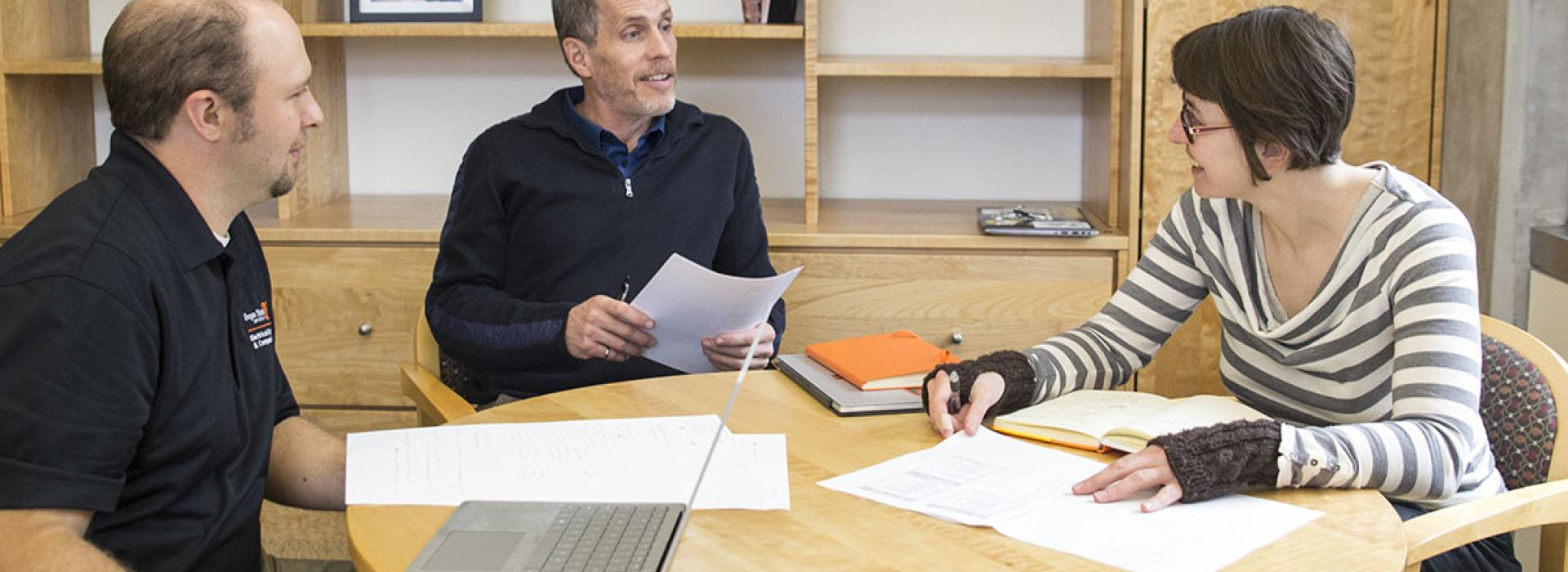 Tom Weller in a meeting with two other people.